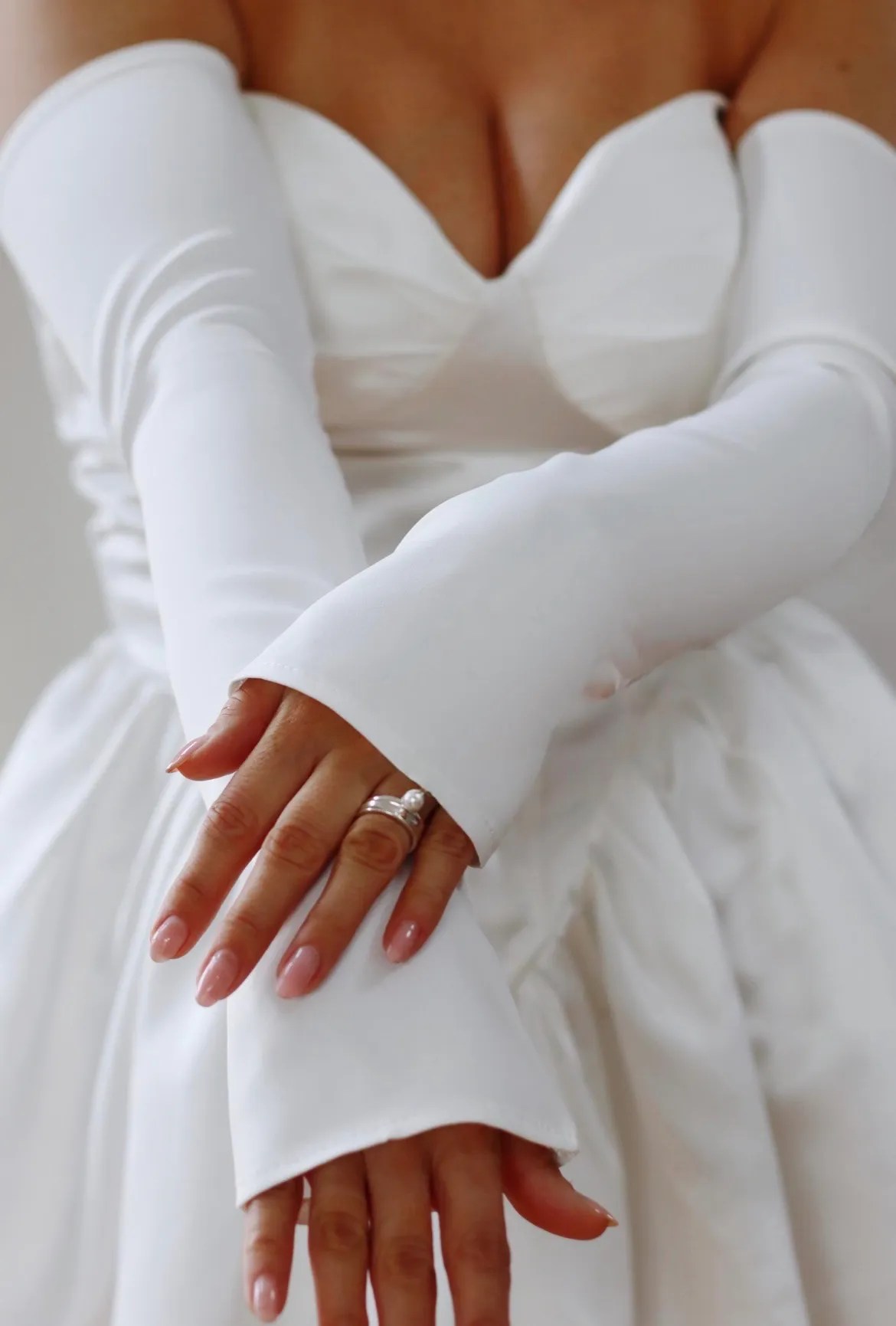 Detachable ivory bridal sleeves styled with a strapless wedding dress for a convertible bridal look