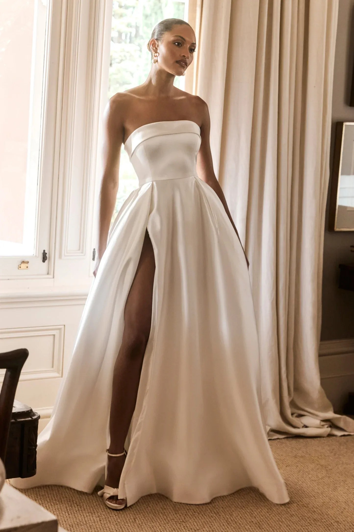 Ivory satin wedding dress with structured strapless bodice and full skirt